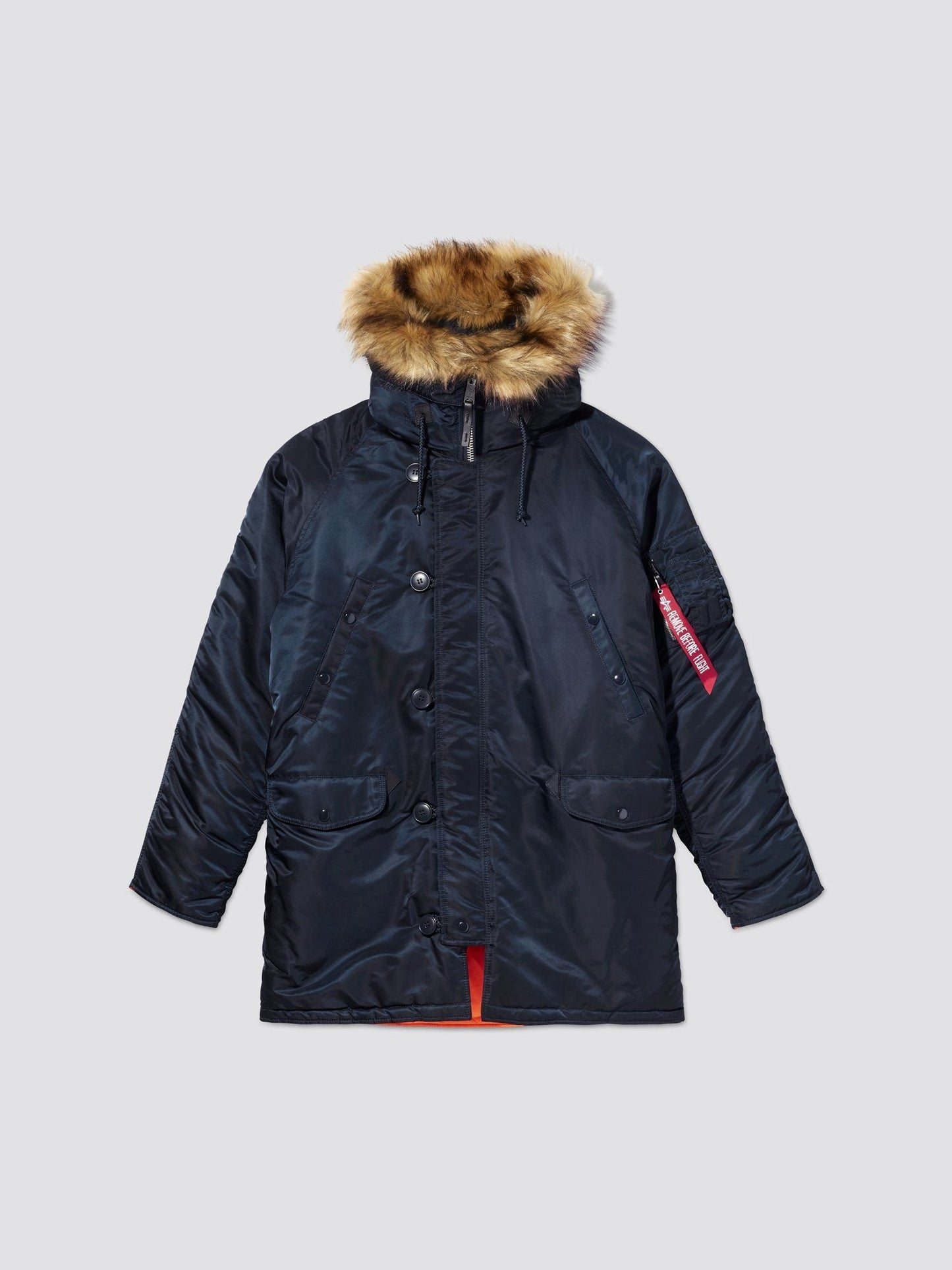 A navy blue Alpha N-3B parka with a contrast lining, hood with fur, and multiple pockets.